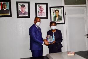 NAFDAC DG handing a complimentary plaque to Mr. Patrick Ajah
